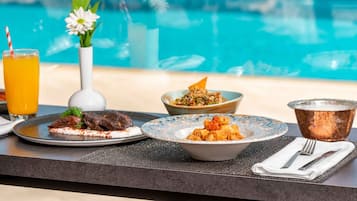 Seasonal outdoor pool, open 7:00 AM to 7:00 PM, free cabanas