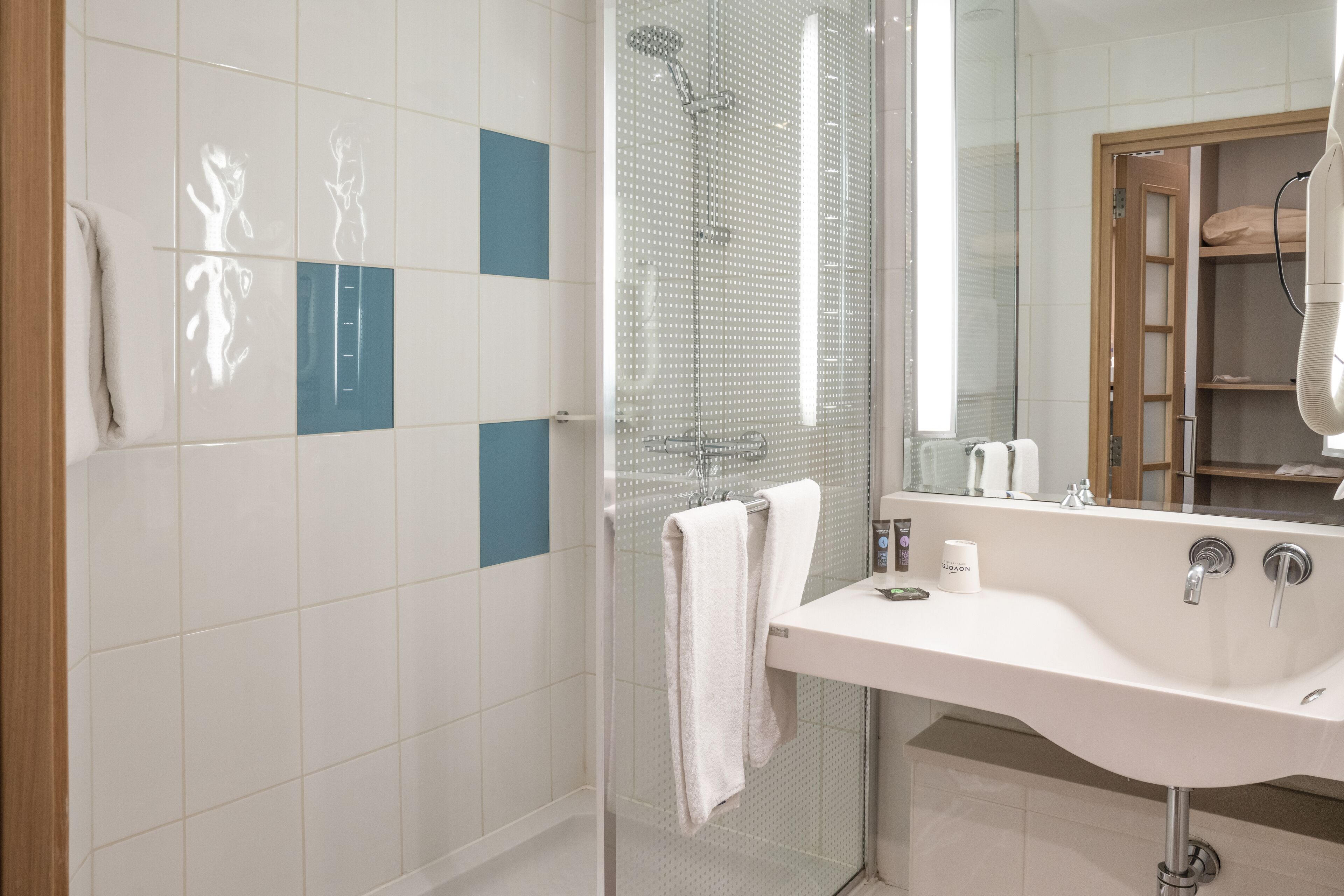 eco-friendly toiletries, hair dryer, slippers, towels