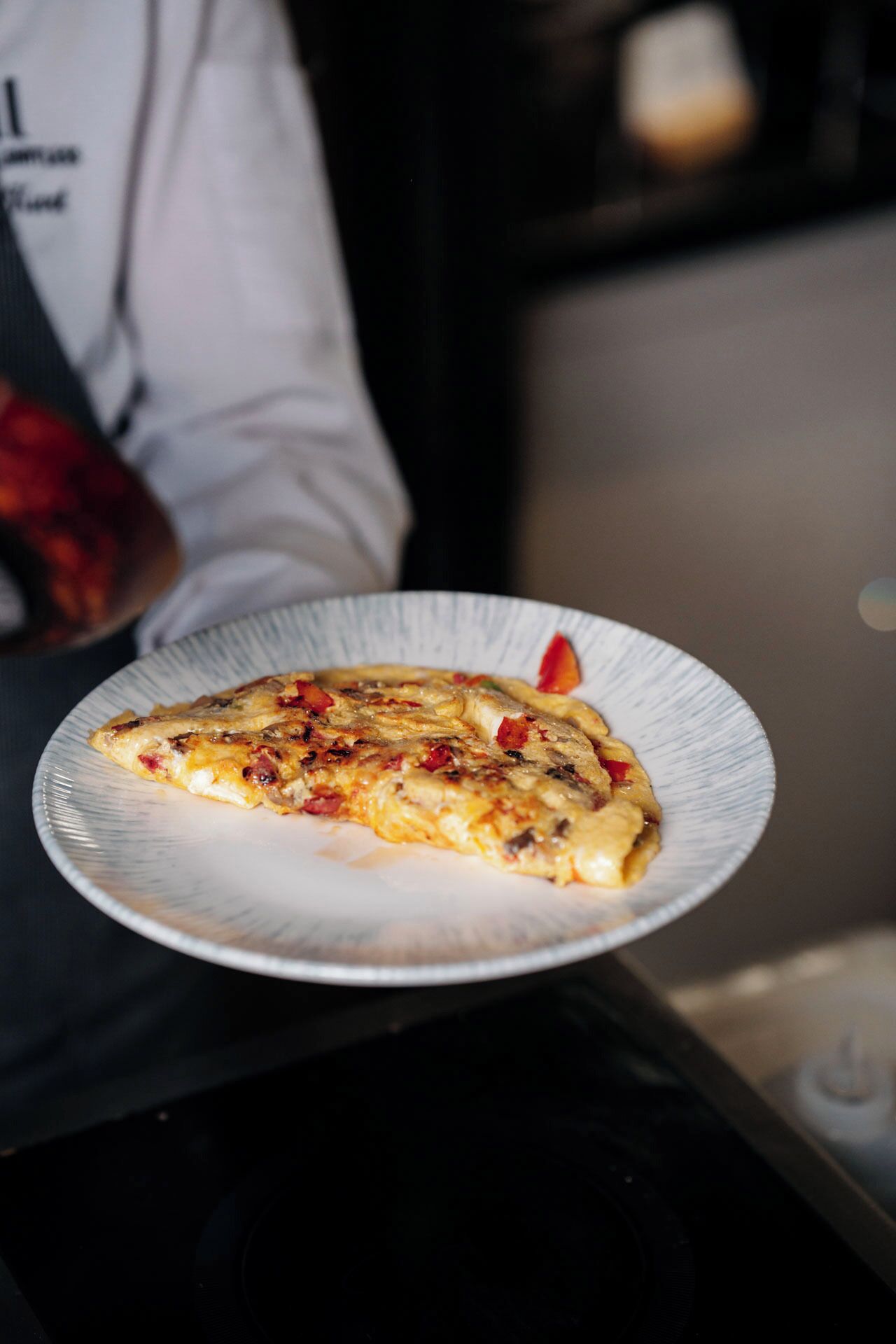 A slice of pizza on a paper plate.