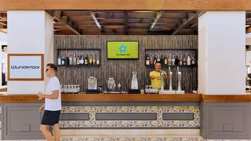 A bar area with a wooden ceiling, a tiled floor, and a sign reading "Wunderbar".