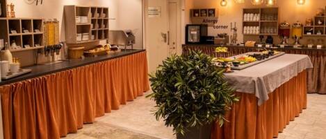 A buffet area with a variety of food items, a sign indicating an allergy corner, and a large potted plant in the center.