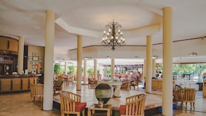 A spacious lobby with high ceilings, a central chandelier, and multiple seating areas. - Aanari Hotel and Spa (Flic-en-Flac)