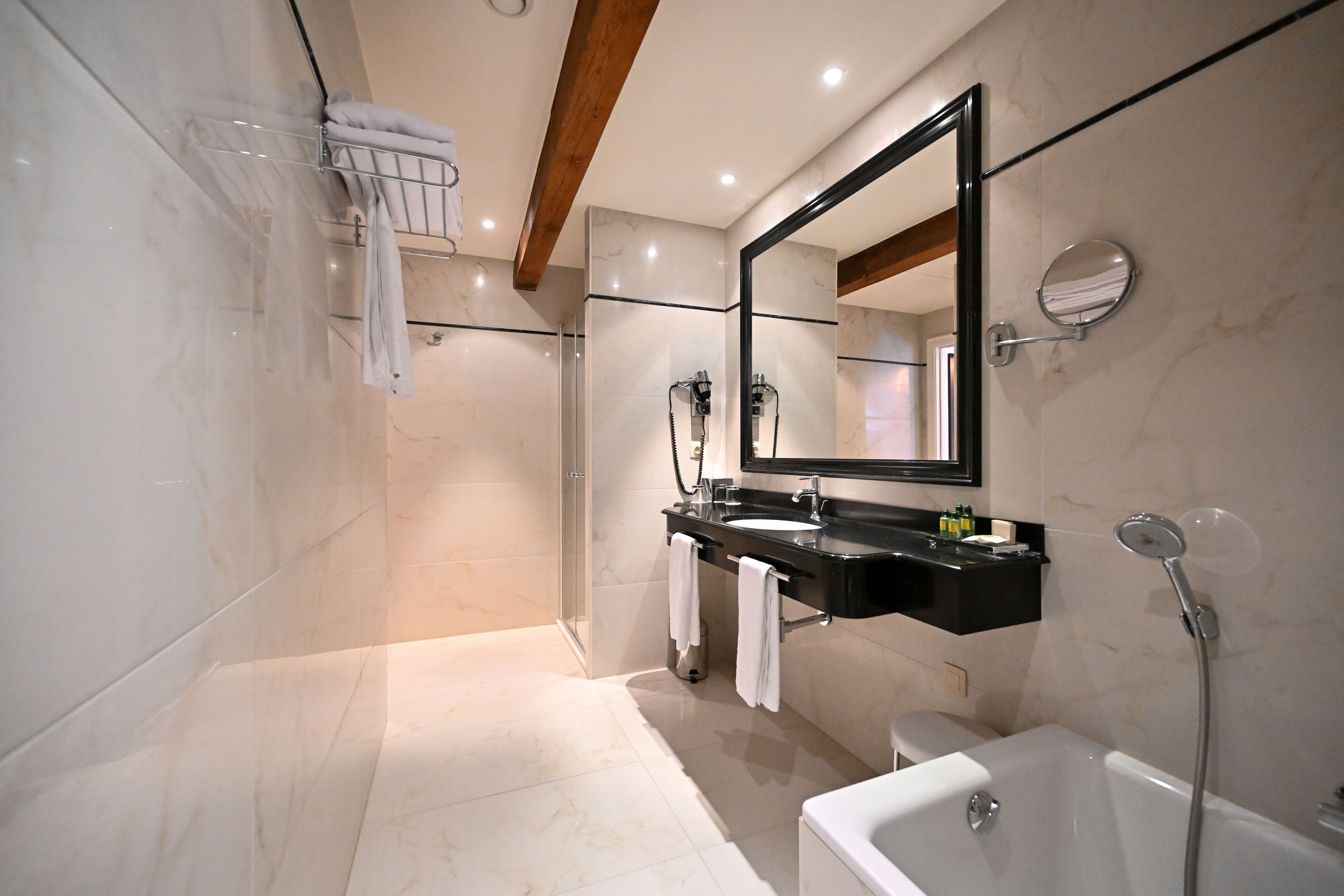 the king loft | bathroom | separate bathtub and shower, designer toiletries, hair dryer, towels