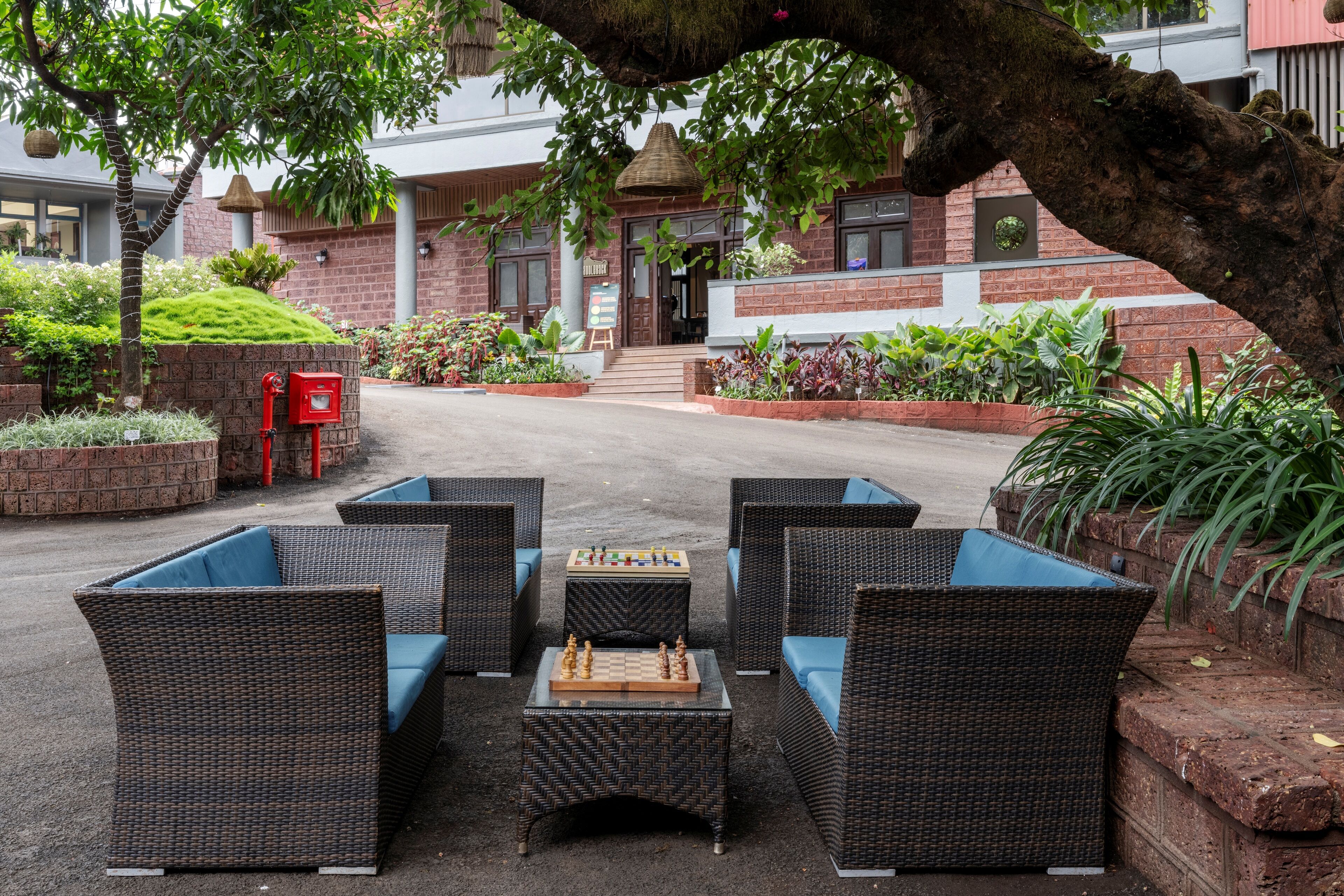 A courtyard with outdoor seating and a chessboard.