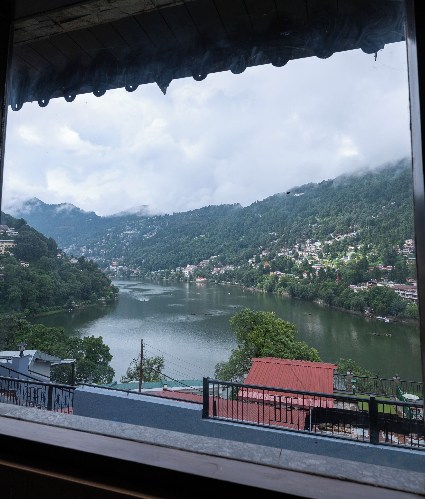 A view of a river surrounded by hills and buildings.