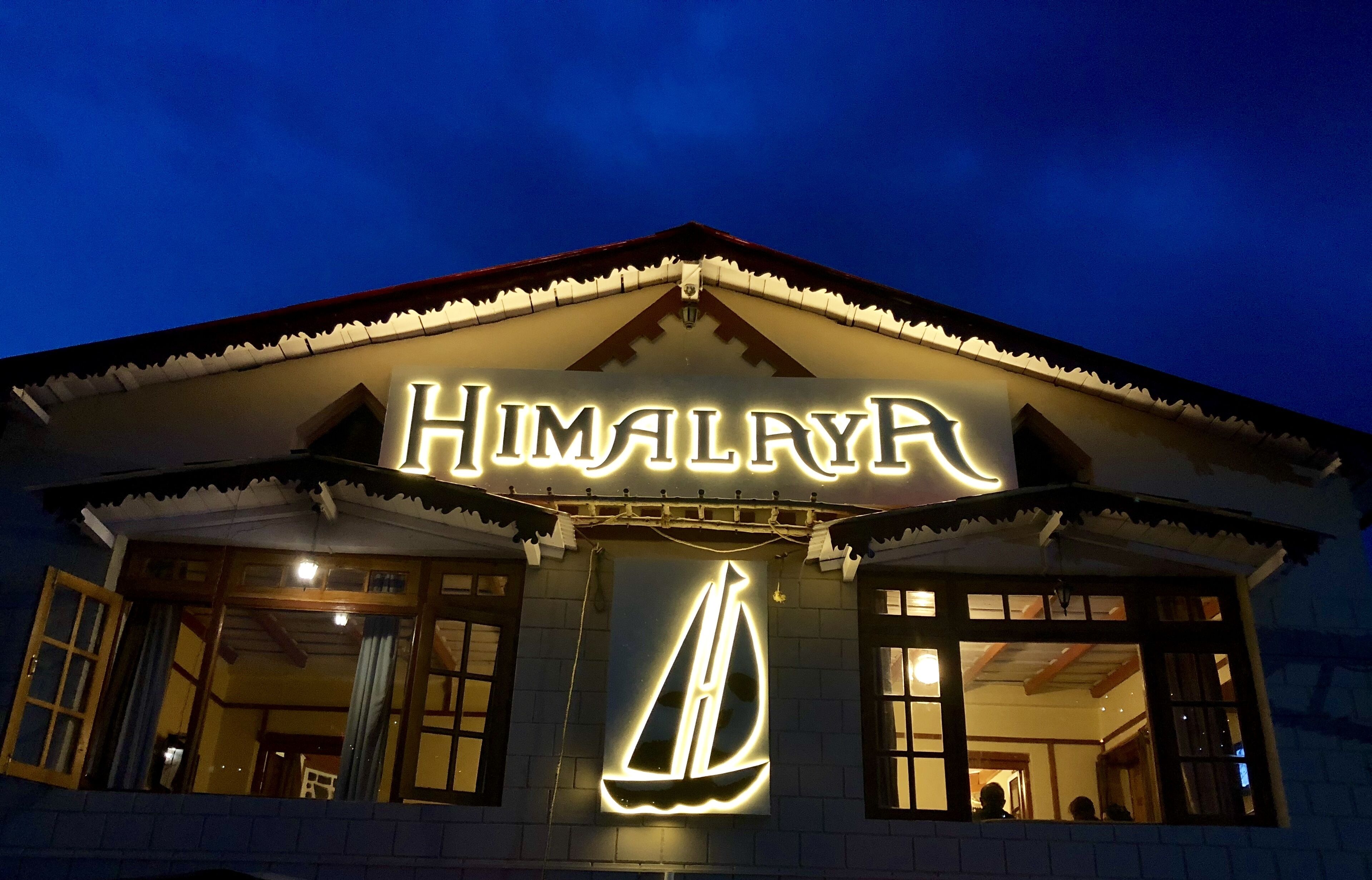 A building with a sign reading "HIMALAYA" and a sailboat symbol.