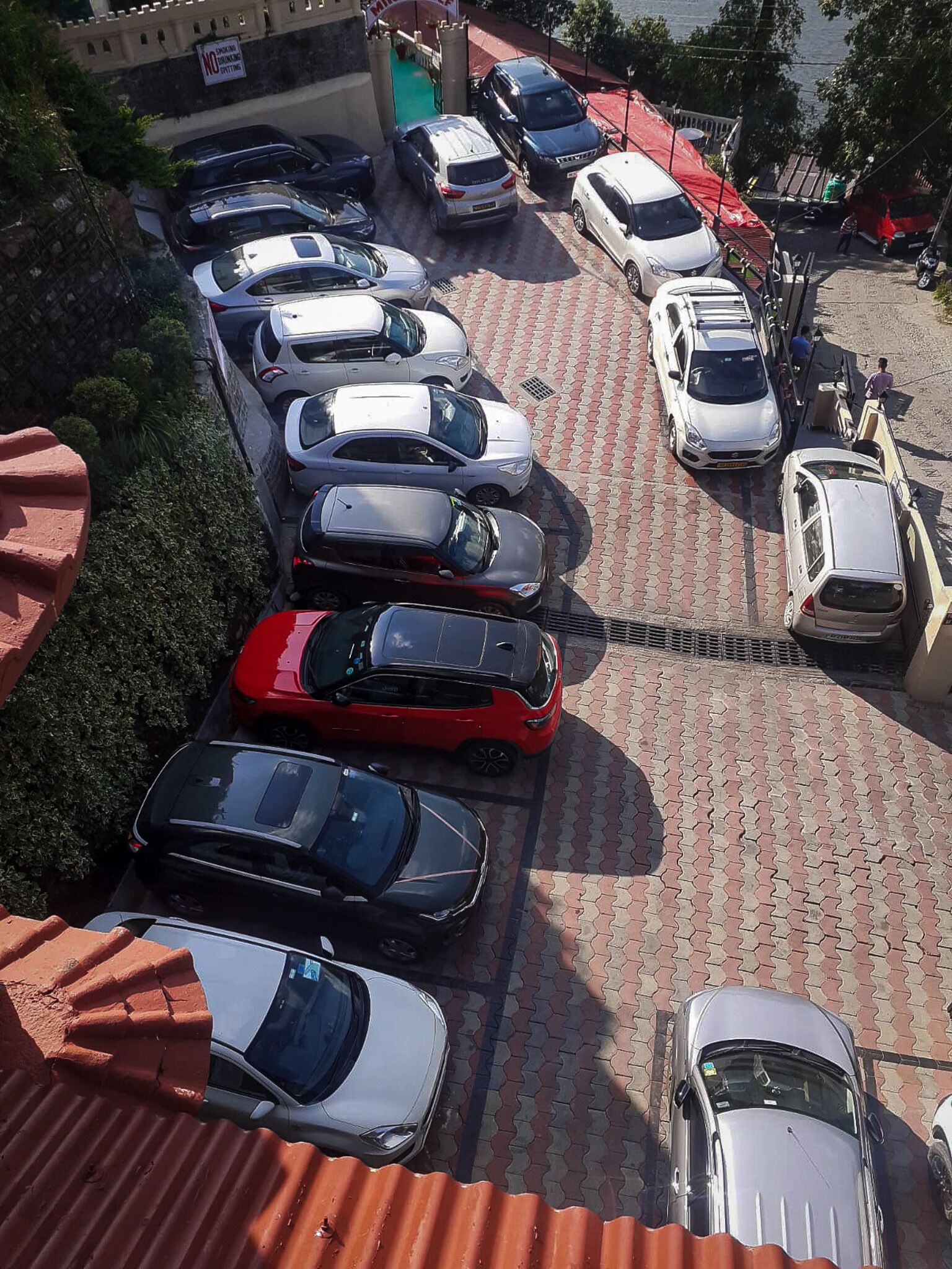 A parking lot with multiple cars parked in rows.