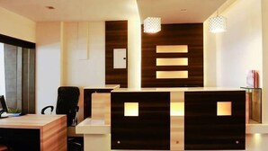 Un mostrador de recepción de diseño moderno, con detalles de madera e iluminación integrada.