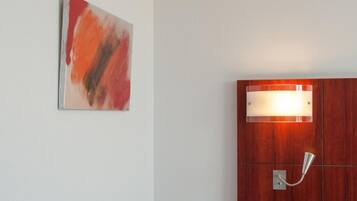 A room with a wooden cabinet and a wall-mounted light fixture.