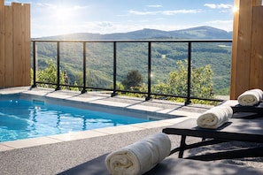 Outdoor pool, open 9:00 AM to 7:00 PM, pool loungers