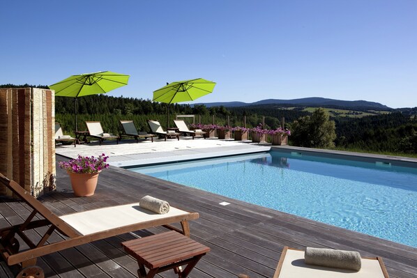 Outdoor pool, open 8 AM to 8 PM, pool loungers