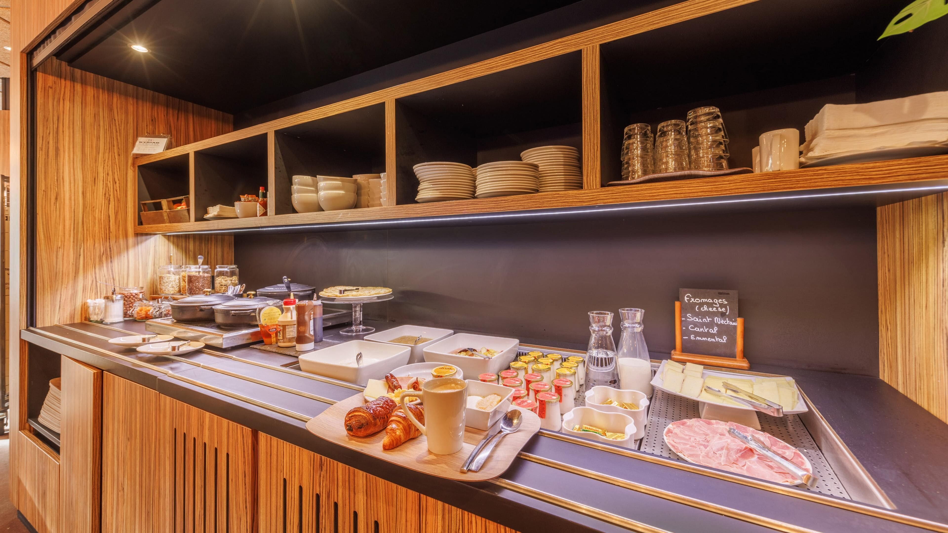 A breakfast buffet with various food items and condiments.