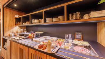 A breakfast buffet with various food items and condiments.