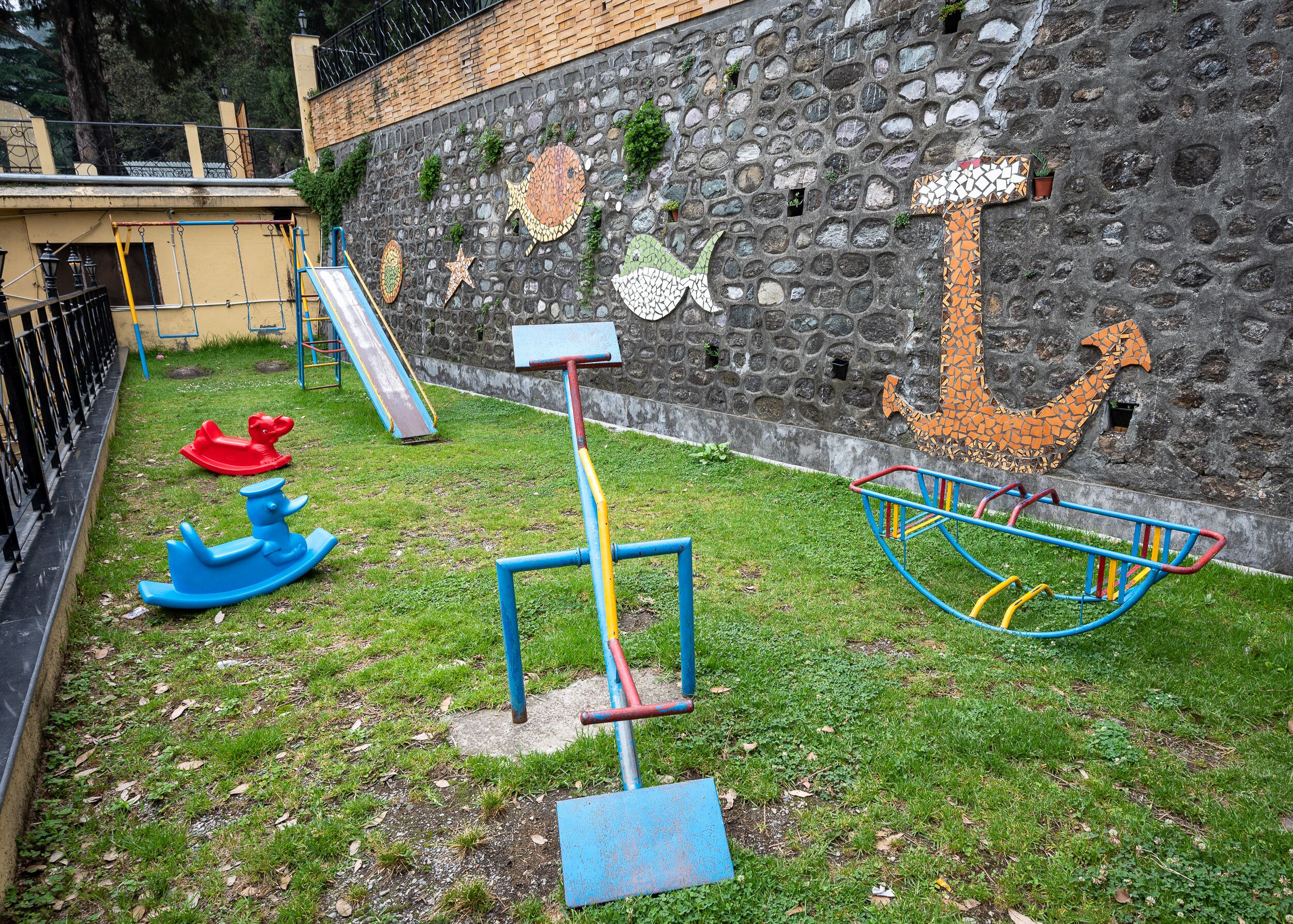 A playground with a slide, swings, and a climbing structure.