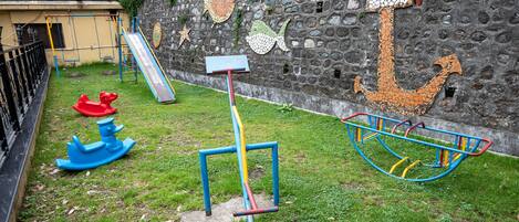 A playground with a slide, swings, and a climbing structure.
