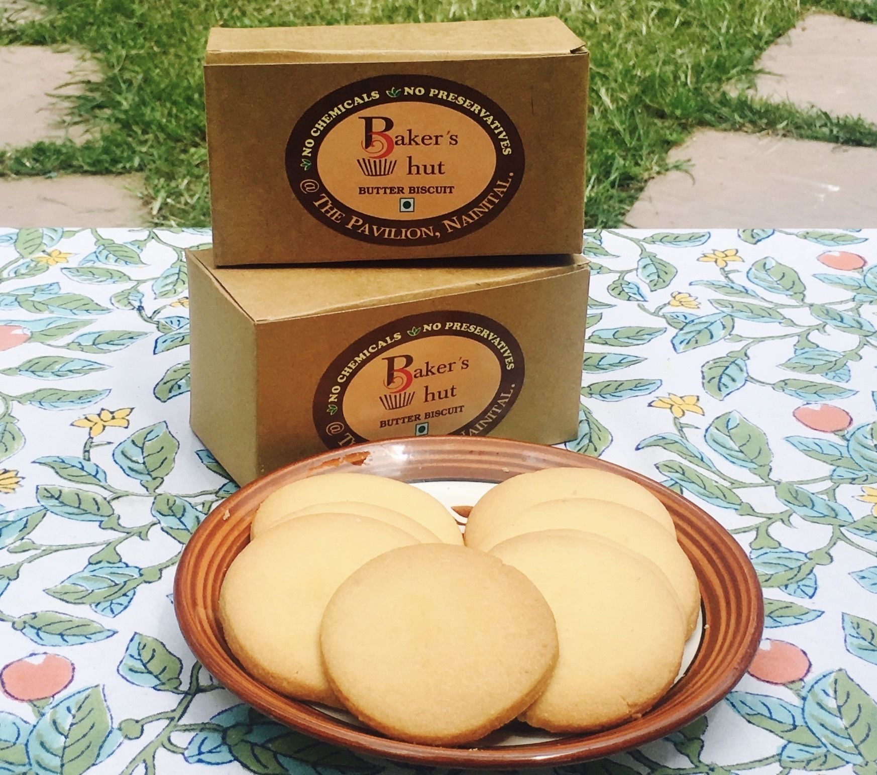 Two cardboard boxes with labels and a plate of cookies.