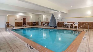 An indoor swimming pool with clear lane markings, a covered seating area, and a tiled floor. - Comfort Suites Medical Center near Six Flags (San Antonio)