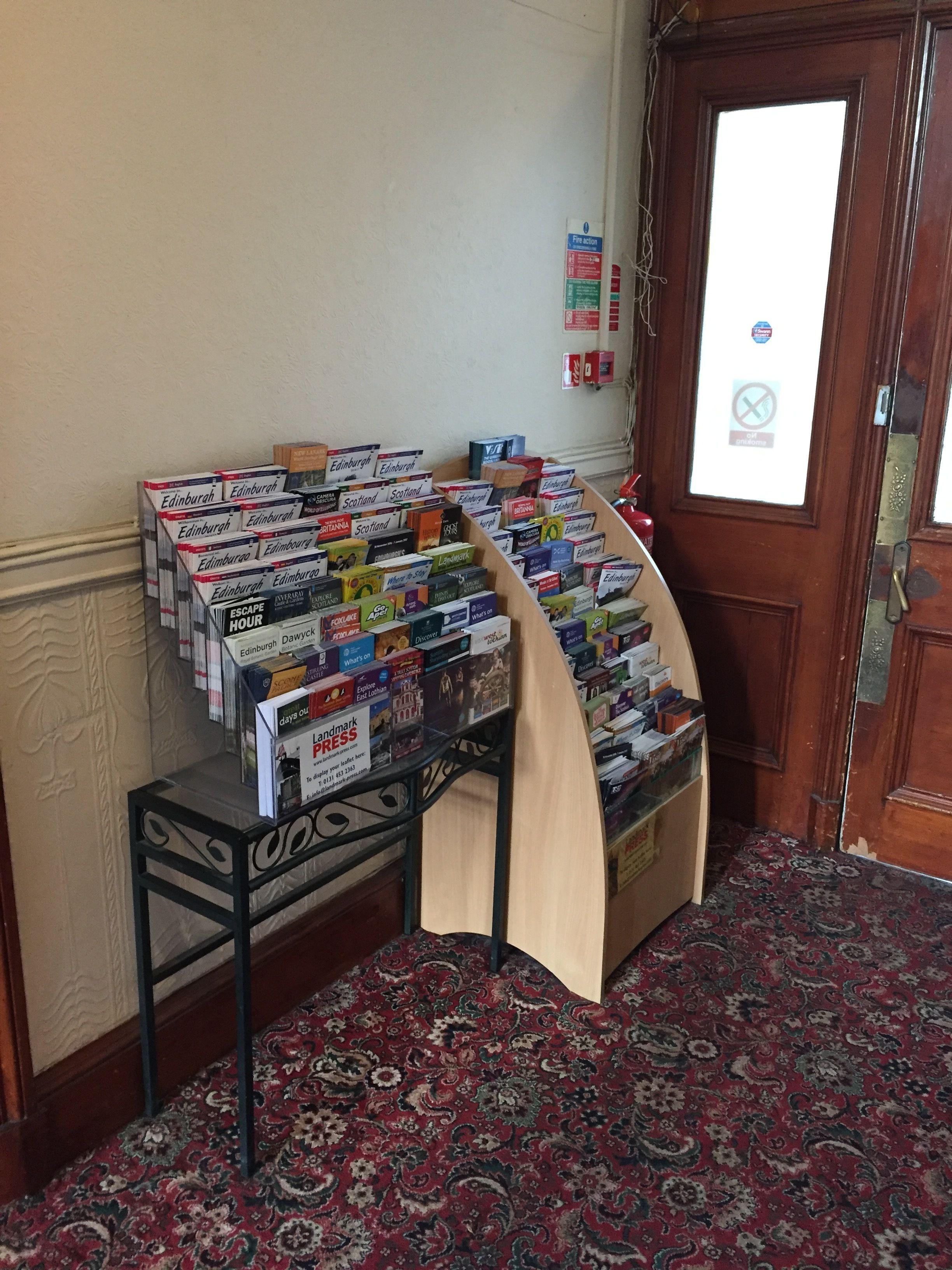 A display of Edinburgh travel guides and books in a hotel lobby.