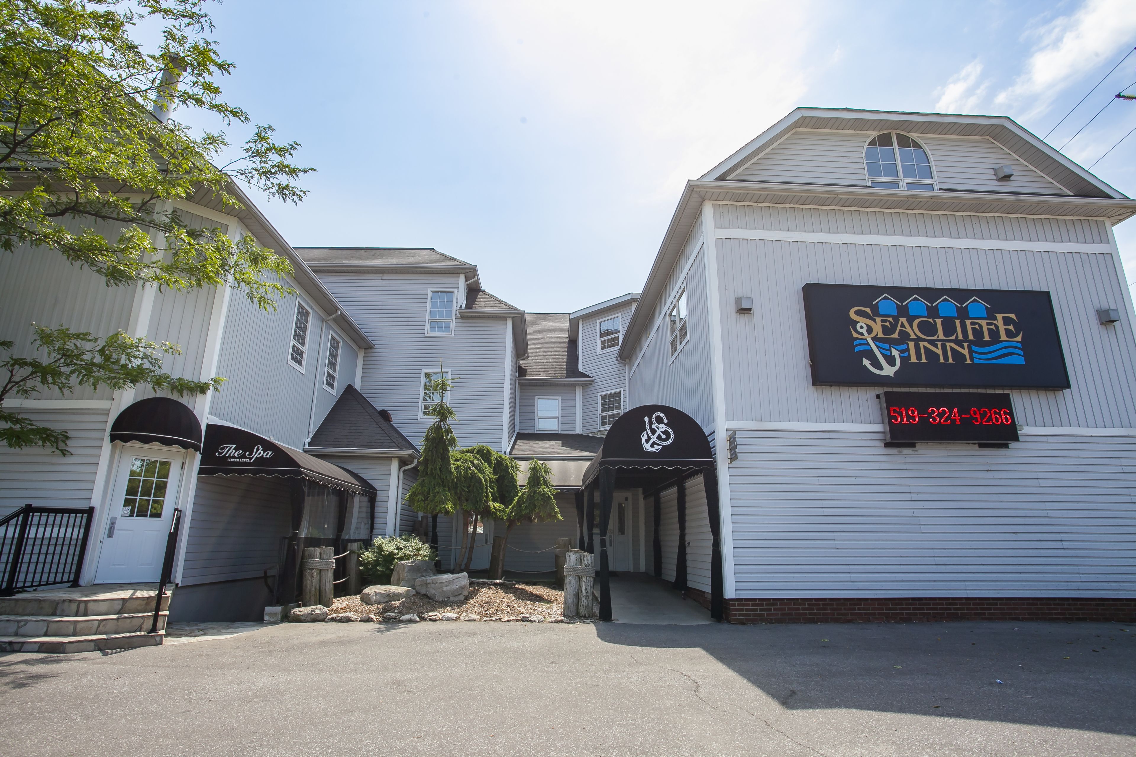 A building with a sign for 'Seacliffe Inn' and a phone number.