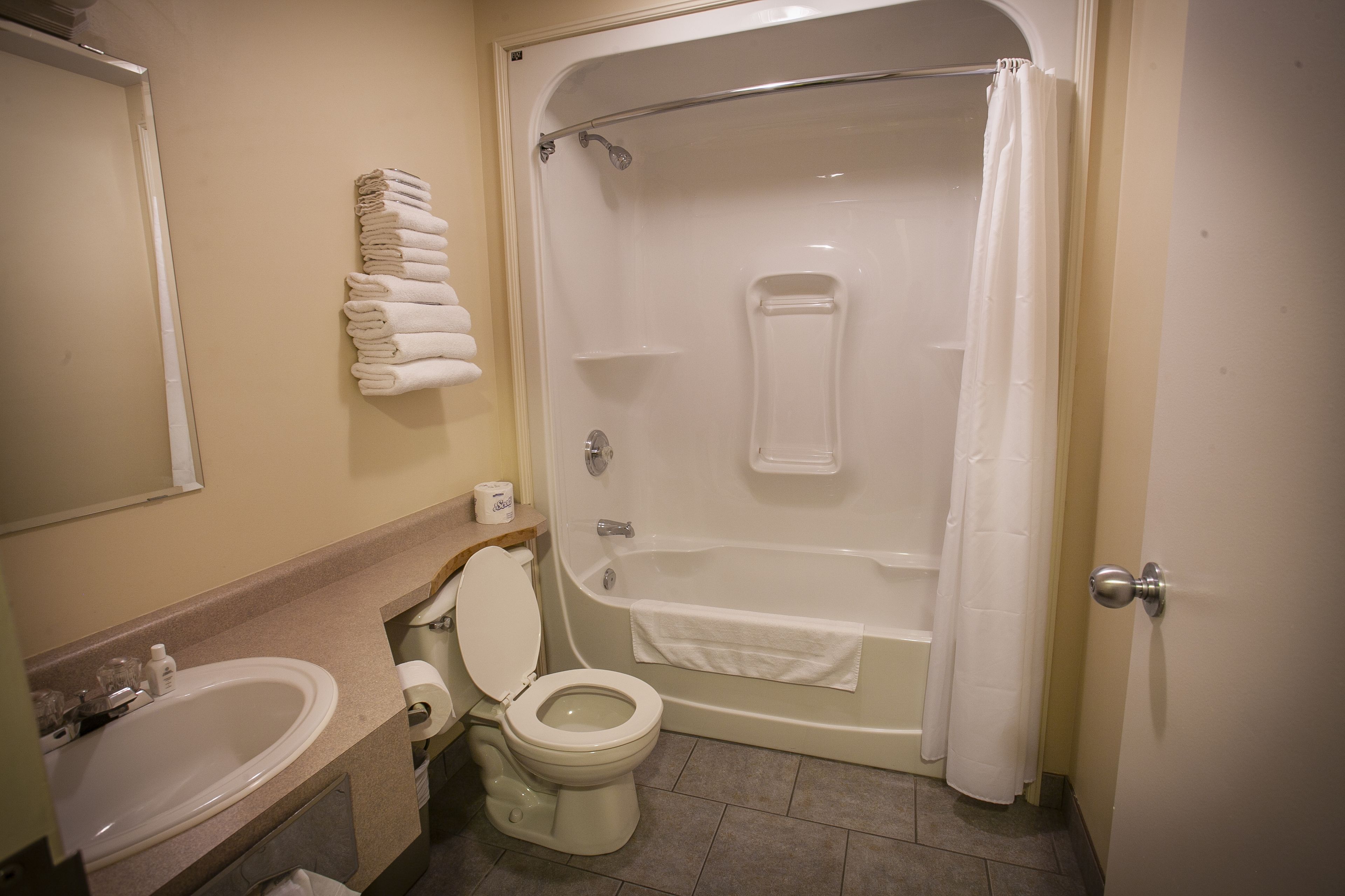A bathroom with a sink, toilet, and bathtub.