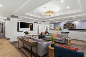 A modern living room with sofas, a coffee table, and a TV.
