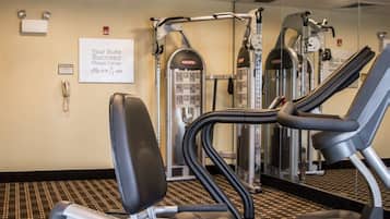 A fitness center with treadmills, weight machines, and a sign indicating it's a suite success fitness center.