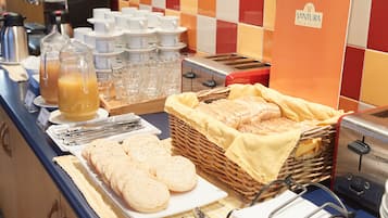 A breakfast buffet with various food items and beverages.