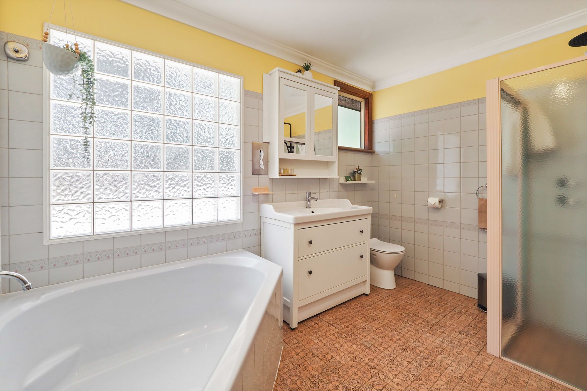 A bathroom with a bathtub, toilet, and shower.