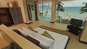 A hotel room with a large bed, a TV, and a view of the beach. - Two Seasons Boracay Resort (Boracay Island)