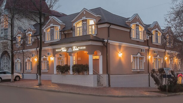 A two-story building with a sign reading "Villa Hotel." - Vila Elat (Chisinau)