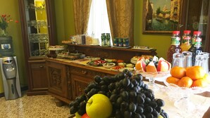 A buffet setup with fruits, vegetables, and beverages. - Vila Elat (Chisinau)