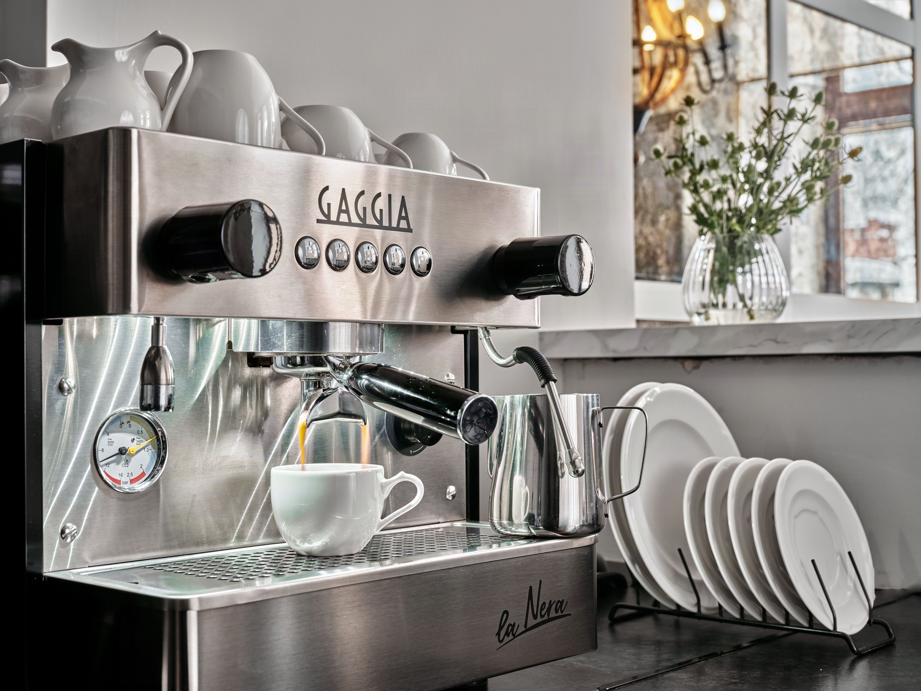 A La Nera espresso machine with a cup holder, a pressure gauge, and a water tank.