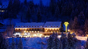 A hotel with multiple floors, a ski lift, and a sign indicating it is a hotel.
