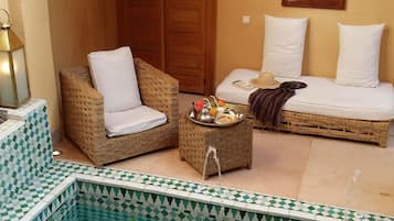 Relax in a cozy space with a comfortable sofa, armchair, and coffee table, perfect for a peaceful stay.