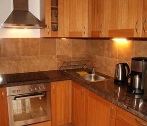 Fridge, microwave, coffee/tea maker, cookware/dishes/utensils