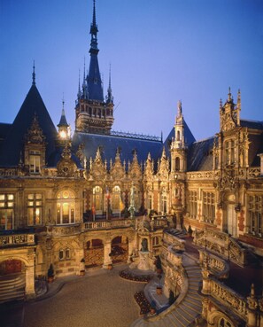 A grand, ornate building with intricate architectural details, including multiple spires and a large central tower. - Auberge du President (Cormeilles)