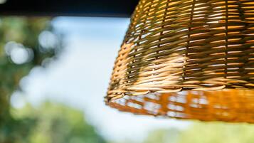 A close-up of a woven hanging light fixture.