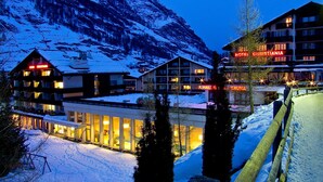 A snow-covered mountain town with Hotel Christiana and other buildings. - Christiania Mountain & Spa (Zermatt)