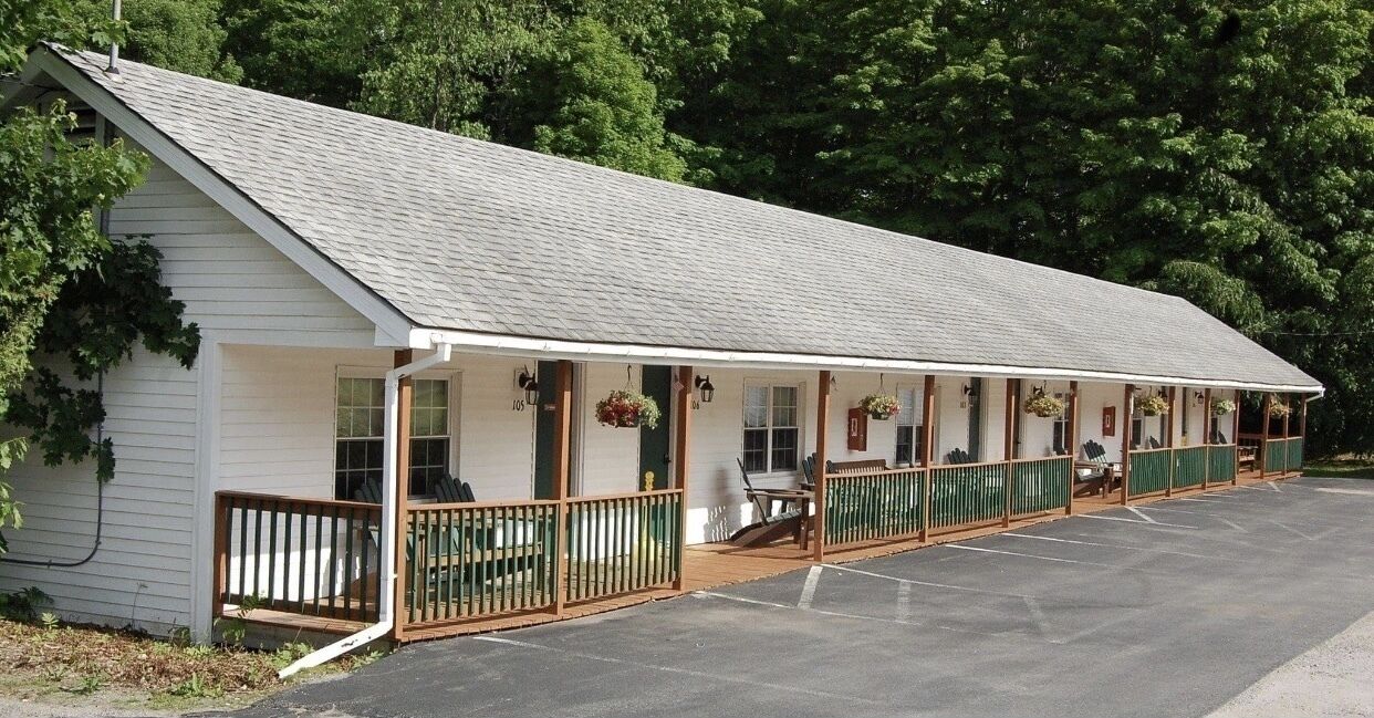 A single-story motel with a covered porch and individual rooms.