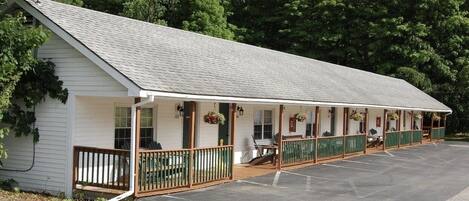 A single-story motel with a covered porch and individual rooms.