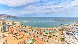 A coastal cityscape with a beach, buildings, and boats. - Leonardo Hotel Fuengirola Costa del Sol (Fuengirola)