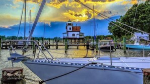 A lighthouse on a pier with boats docked nearby. - Inner Banks Inn (Edenton)