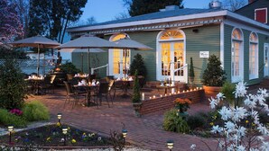 A cozy patio area with outdoor seating and a well-lit entrance. - Inner Banks Inn (Edenton)