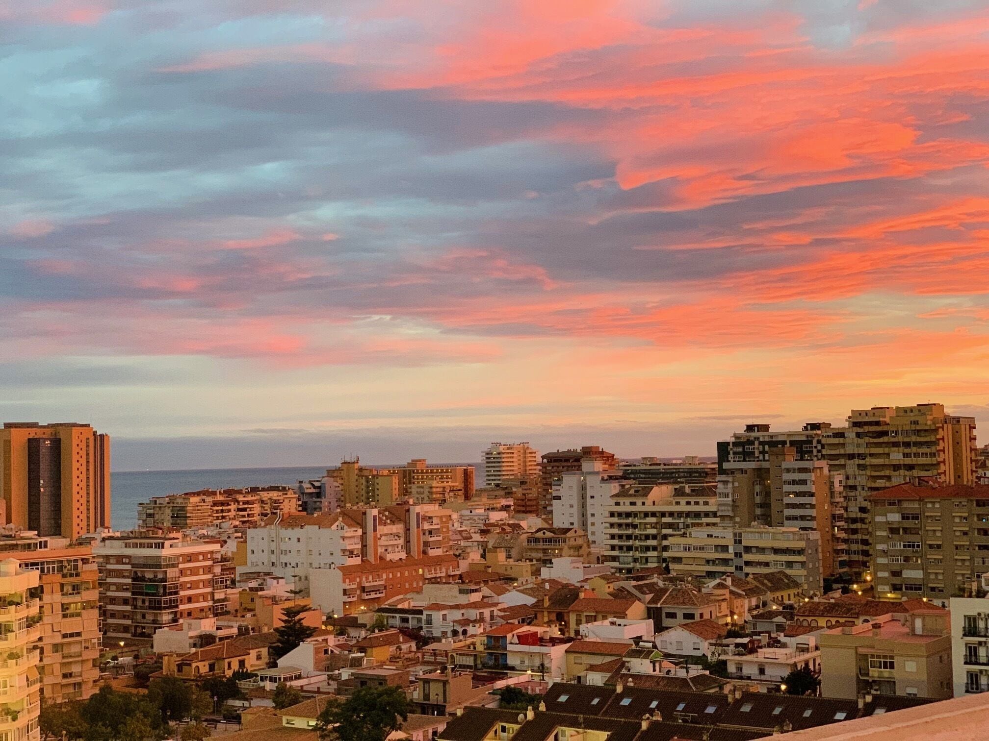 A cityscape with a variety of building heights and architectural styles, including both residential and commercial structures.