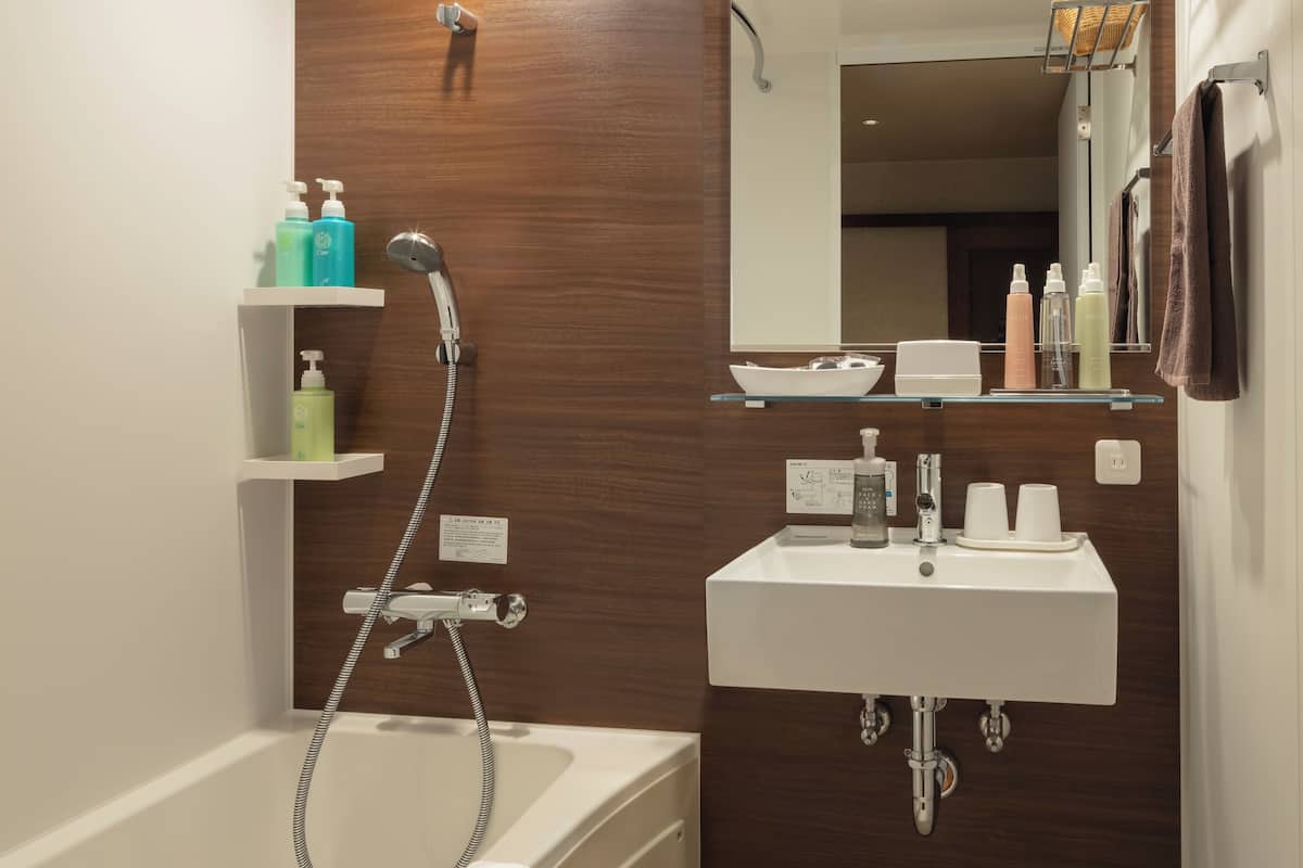 partial sea view twin, accommodates up to 2 guests, non-smoking | bathroom | combined shower/bathtub, free toiletries, hair dryer, slippers