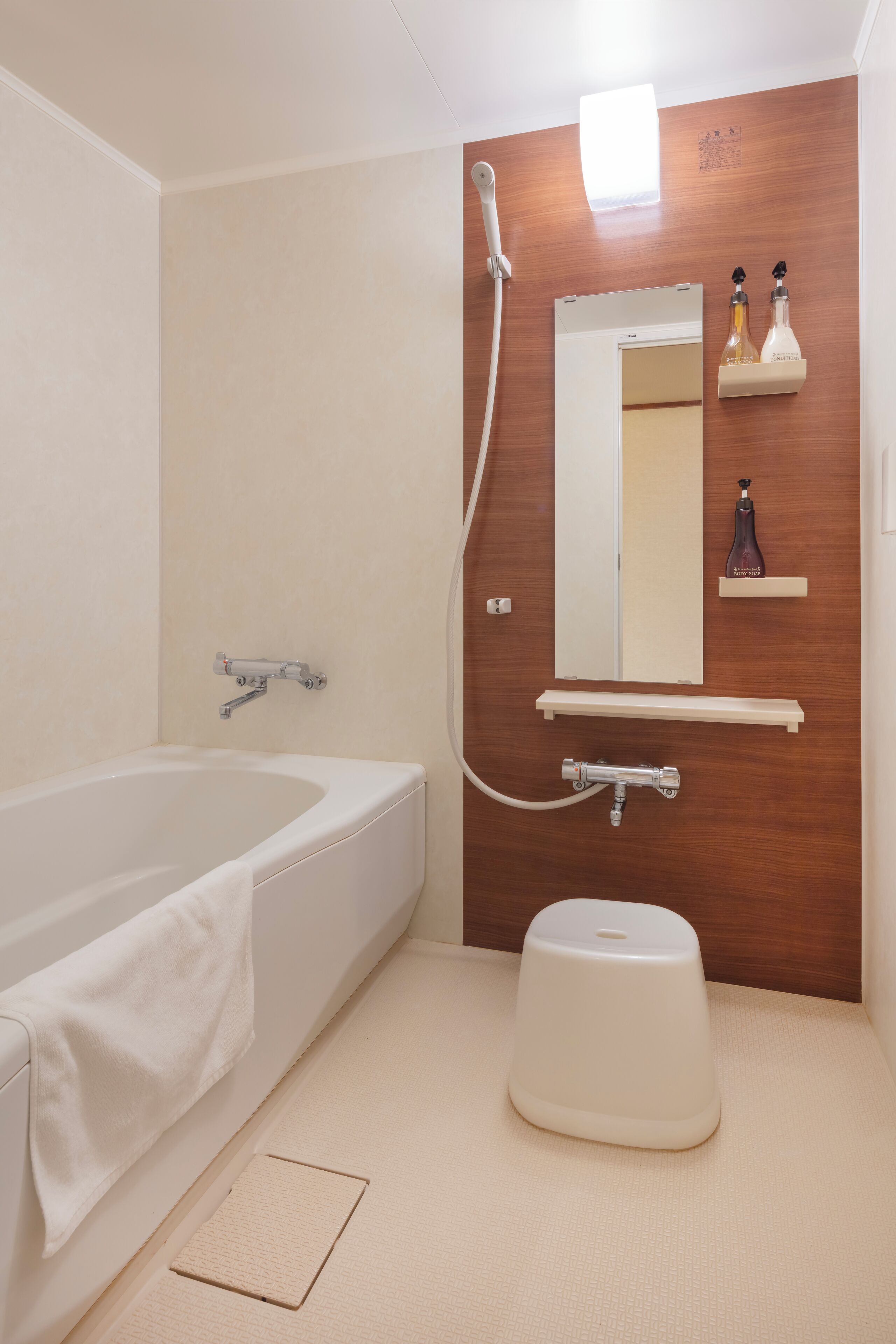 A modern bathroom with a bathtub, a shower, a toilet, and a sink.