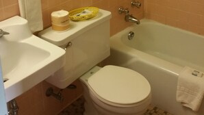A bathroom with a toilet, sink, and bathtub. - Budget Inn (Heber Springs)