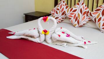 Rest in comfort with a neatly made bed, complete with two plush bathrobes and a stylish headboard.