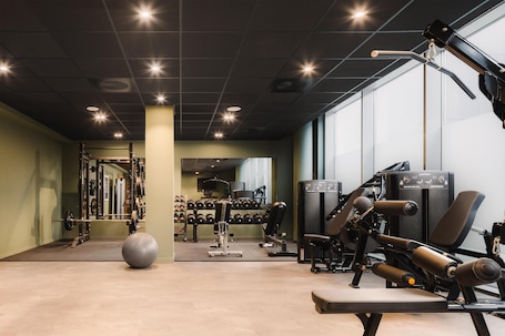 A gym with weightlifting equipment, exercise balls, and a mirrored wall.. Scandic Stavanger Airport