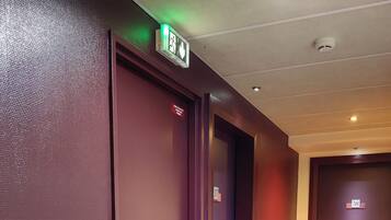 A hallway with three doors, each marked with a number.